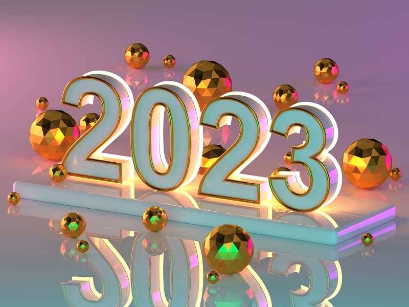 "2023 in bold numbers surrounded by shiny gold spheres on a reflective surface, symbolizing the year and technological advancements presented at Geekzilla CES 2023."