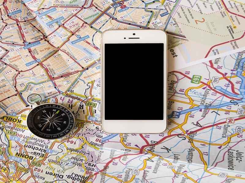 "A map of Mexico with a compass and a smartphone placed on top, symbolizing travel planning and navigation for exploring the country's key regions, cities, and tourist destinations."